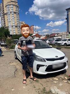 Выдача автомобиля Kia: клиент у машины (лицо скрыто, номер закрыт)
